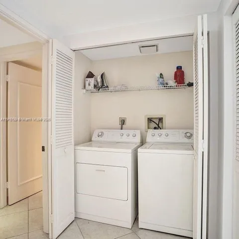 a view of storage and utility room with washer and dryer