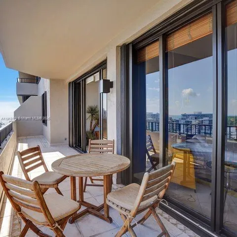 a view of a dining room with furniture wooden floor and a floor to ceiling window