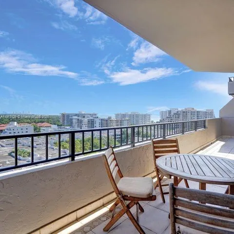a view of a balcony with an outdoor seating