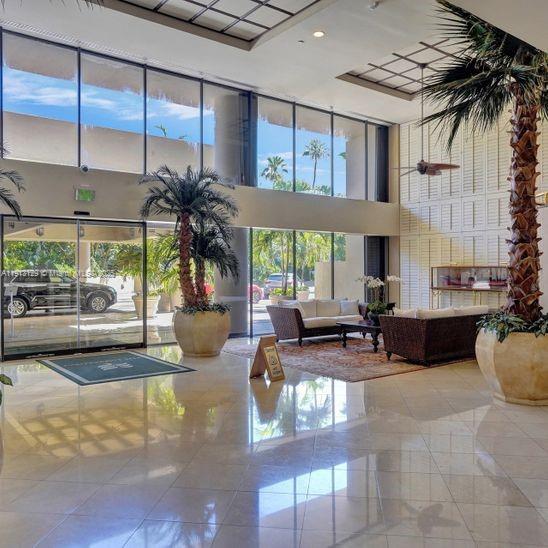 151 Crandon Boulevard, Unit 1130 Key Biscayne, FL 33149 - Photo 38 of 39 a living room with fireplace furniture and a potted plant