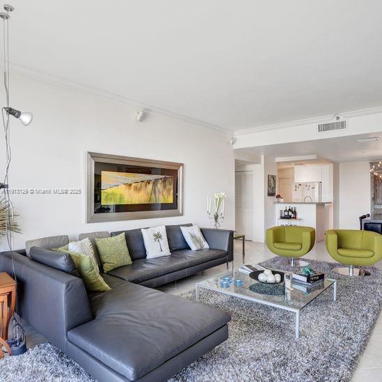 151 Crandon Boulevard, Unit 1130 Key Biscayne, FL 33149 - Photo 4 of 39 a living room with a couch and a table