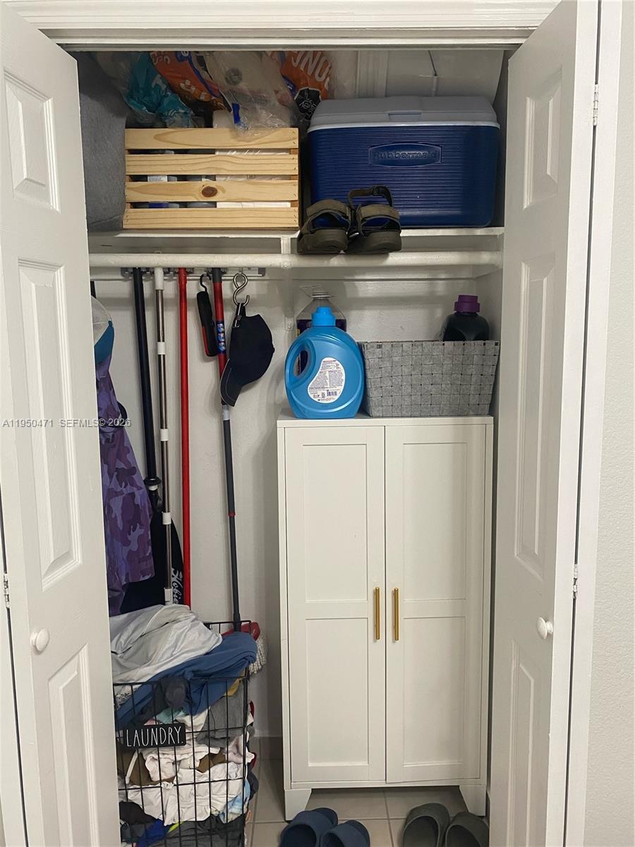 606 West 81st Street, Unit 210 Hialeah, FL 33014 - Photo 11 of 19 a view of walk in closet with clothes and shoes