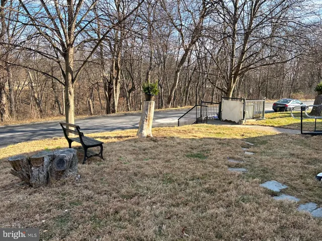 a view of a swimming pool with sitting area and tub