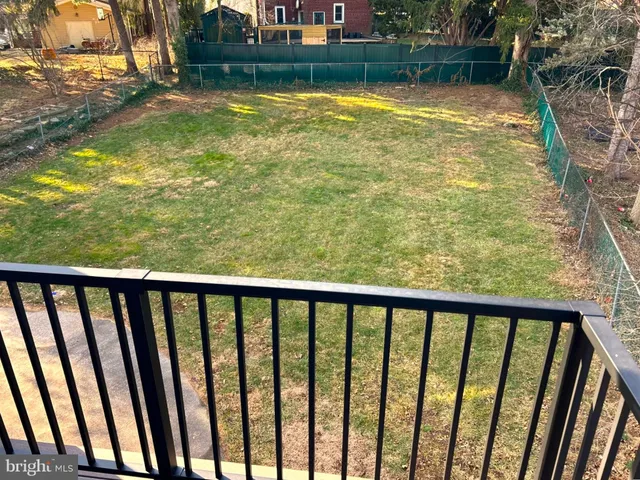 a view of a balcony with a yard