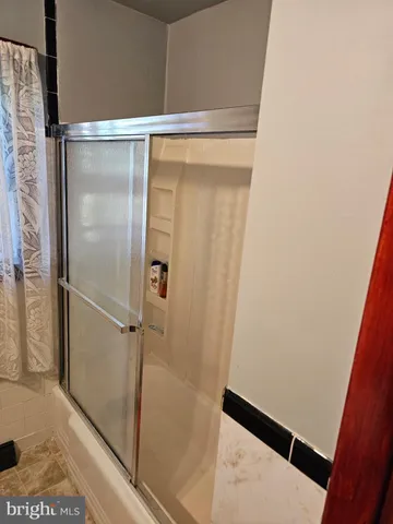 a bathroom with a glass shower door