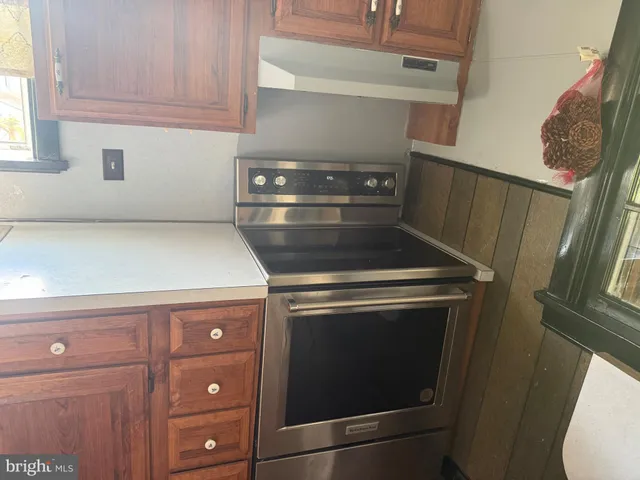 a stove top oven sitting inside of a kitchen