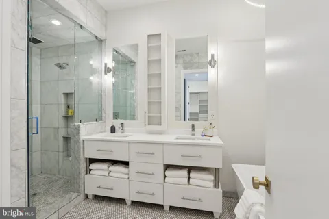 a bathroom with a bathtub and a shower