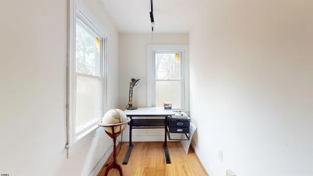 a view of a livingroom with a table and a chair