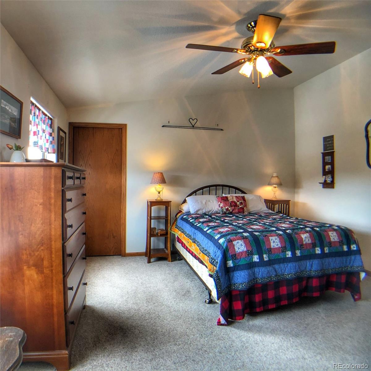 1600 Commanche Road Westcliffe, CO 81252 - Photo 13 of 31 a bedroom with a bed and a chandelier