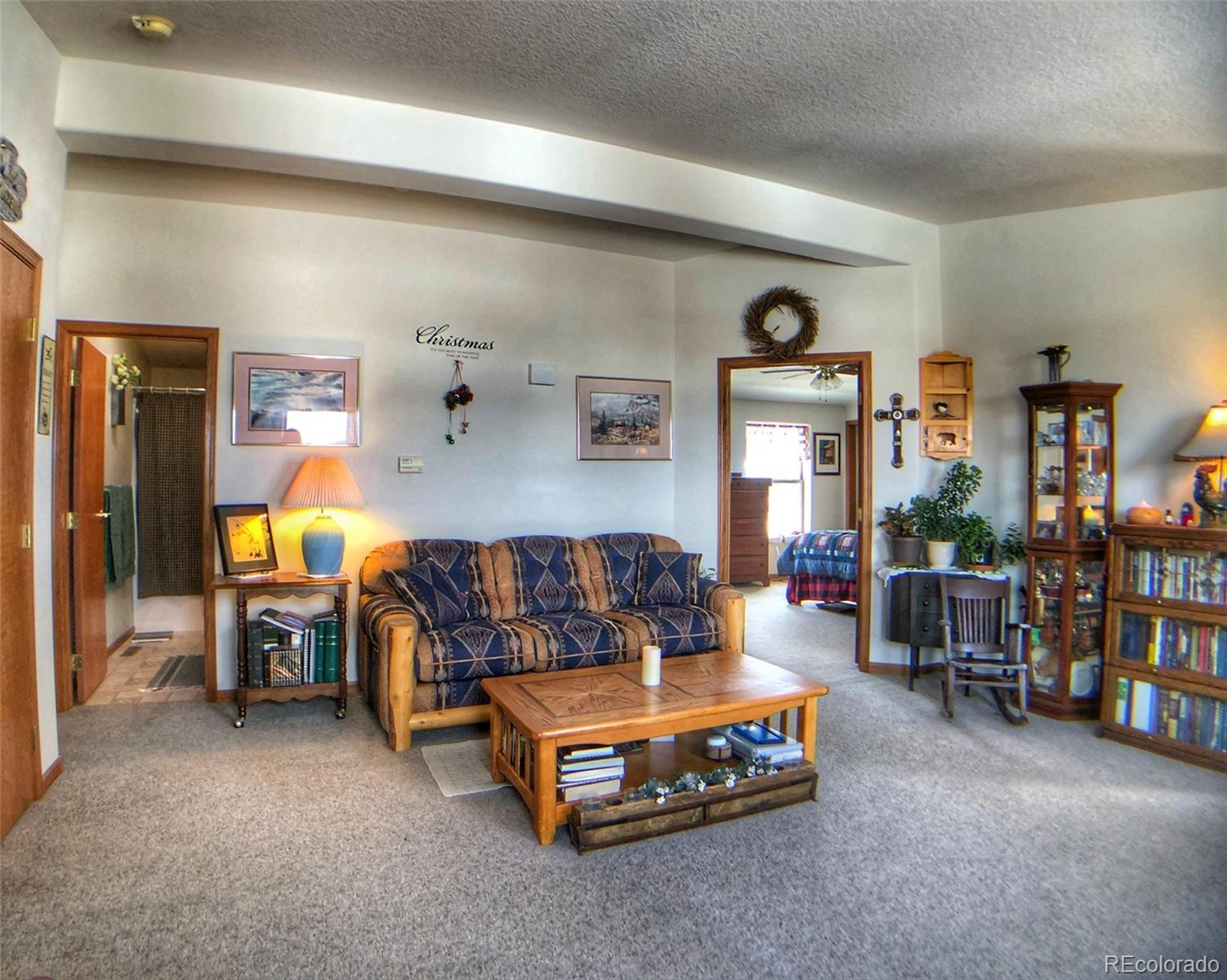 1600 Commanche Road Westcliffe, CO 81252 - Photo 19 of 31 a bedroom with furniture and a lamp