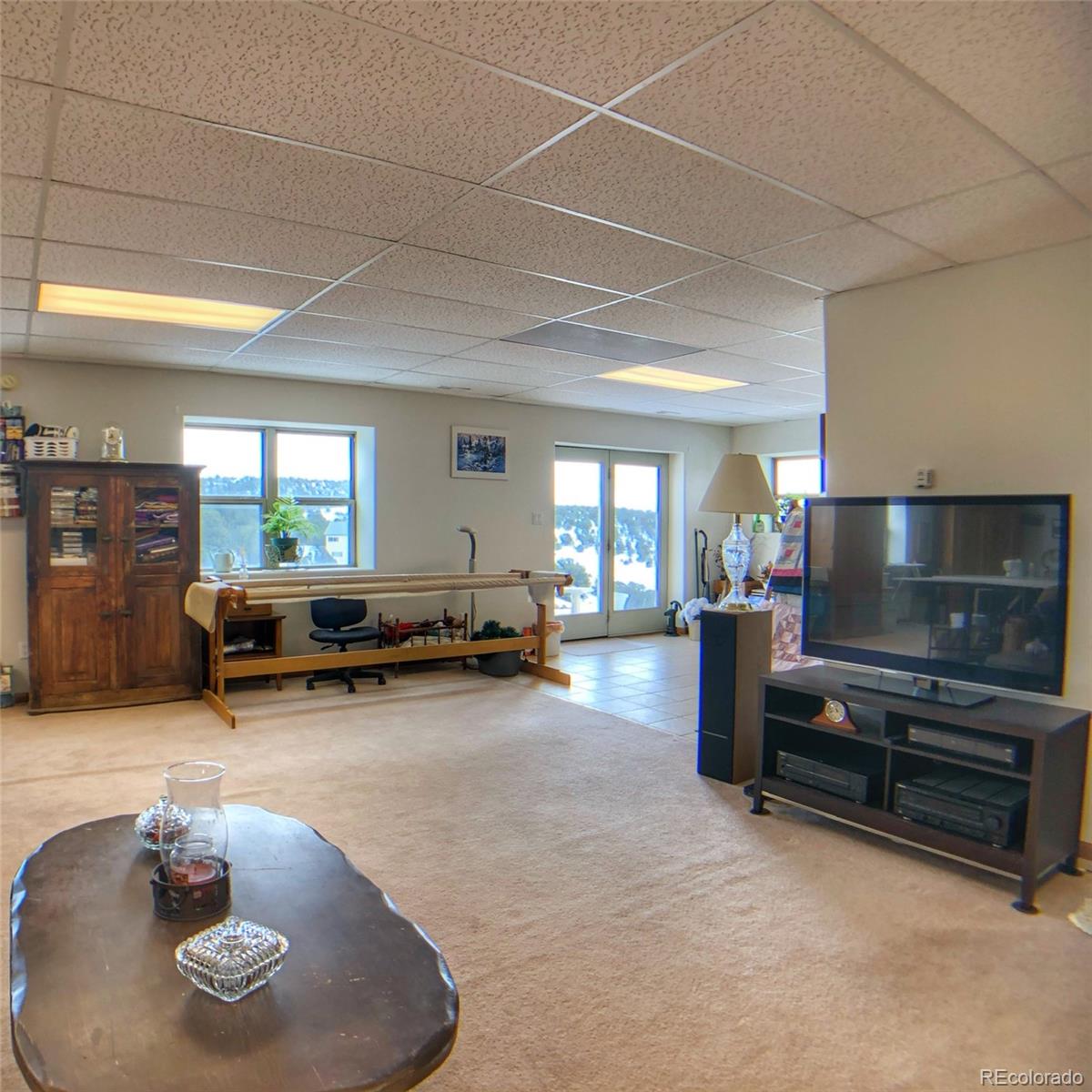 1600 Commanche Road Westcliffe, CO 81252 - Photo 24 of 31 a living room with furniture and a flat screen tv
