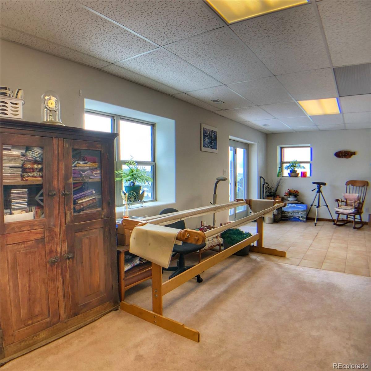 1600 Commanche Road Westcliffe, CO 81252 - Photo 25 of 31 a living room with furniture gym equipment and a window
