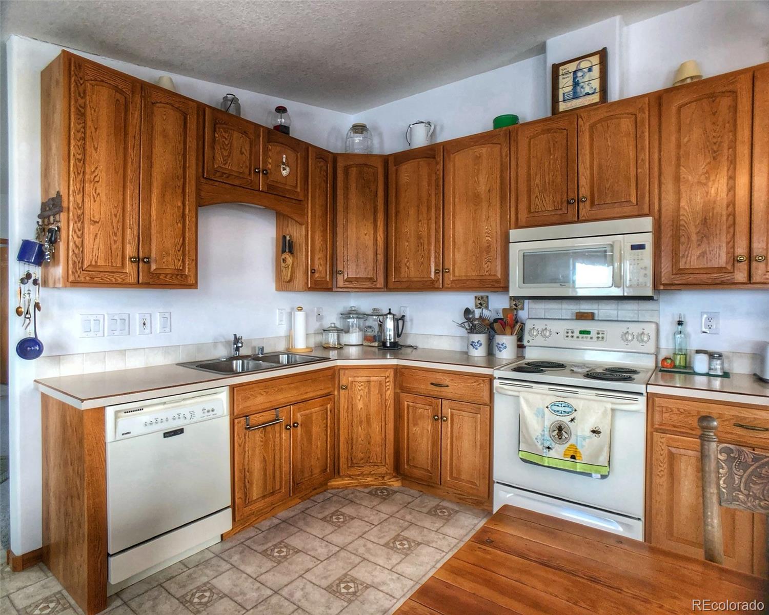 1600 Commanche Road Westcliffe, CO 81252 - Photo 6 of 31 a kitchen with stainless steel appliances granite countertop a stove a sink and a microwave