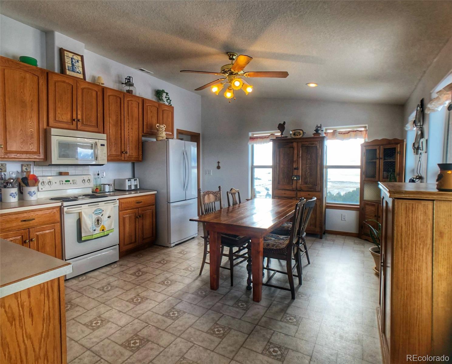 1600 Commanche Road Westcliffe, CO 81252 - Photo 7 of 31 a kitchen with stainless steel appliances kitchen island granite countertop a sink counter space and cabinets