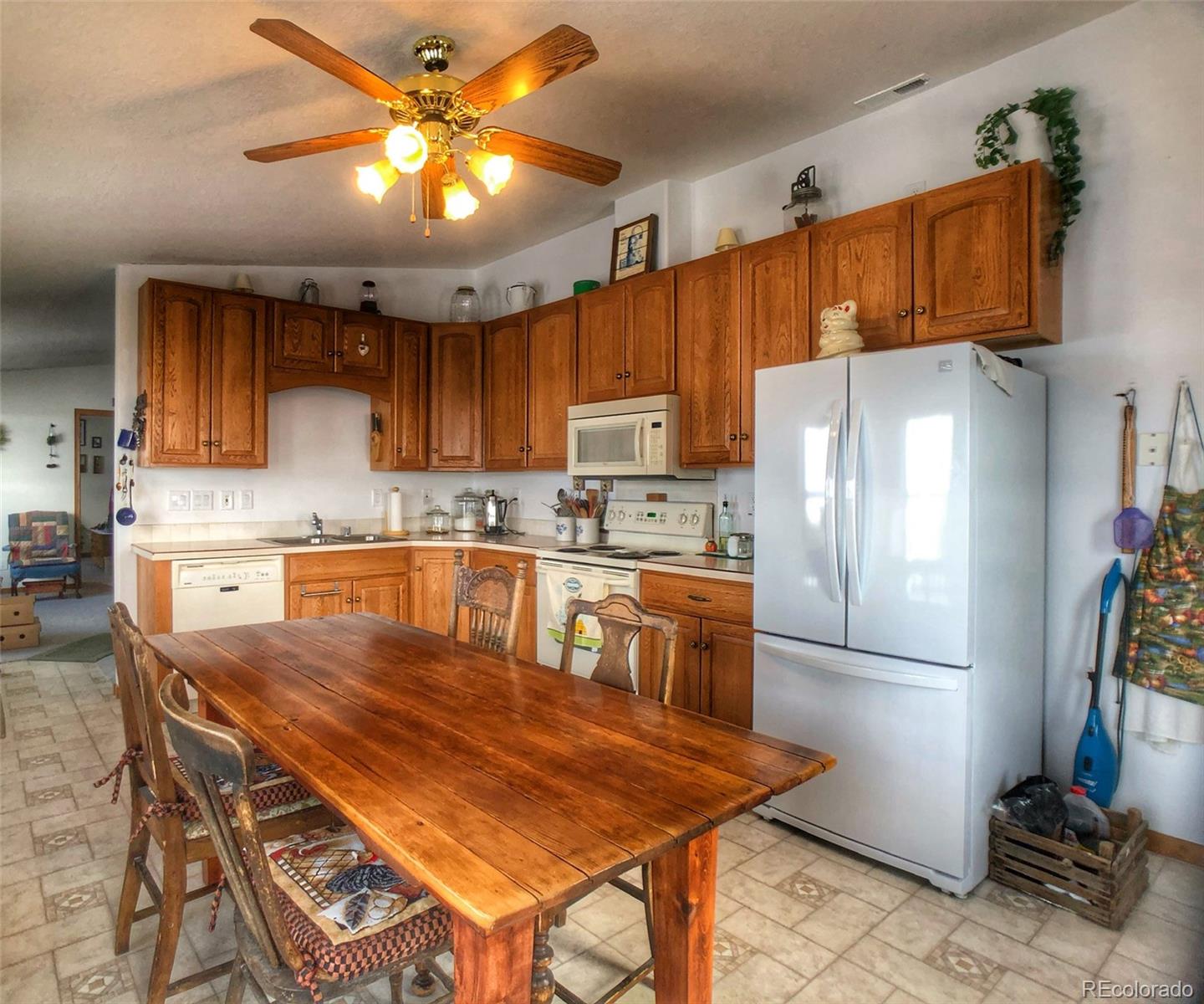 1600 Commanche Road Westcliffe, CO 81252 - Photo 9 of 31 a kitchen with stainless steel appliances granite countertop a refrigerator a stove top oven a sink dishwasher and white cabinets