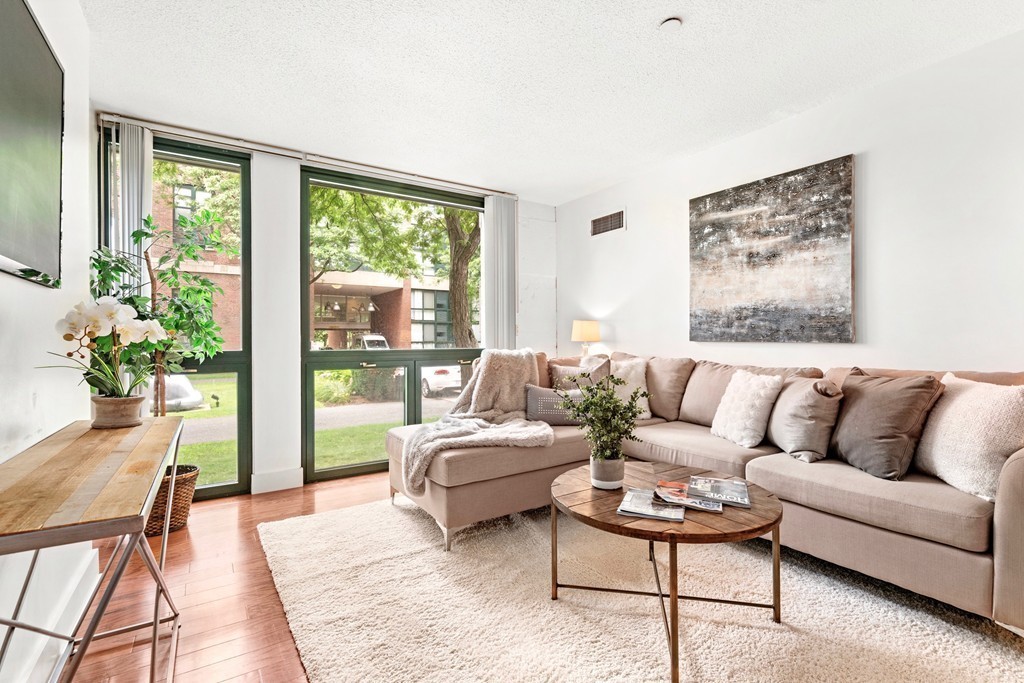 42 8th Street, Unit 5109 Boston, MA 02129 - Photo 1 of 17 a living room with furniture and a large window