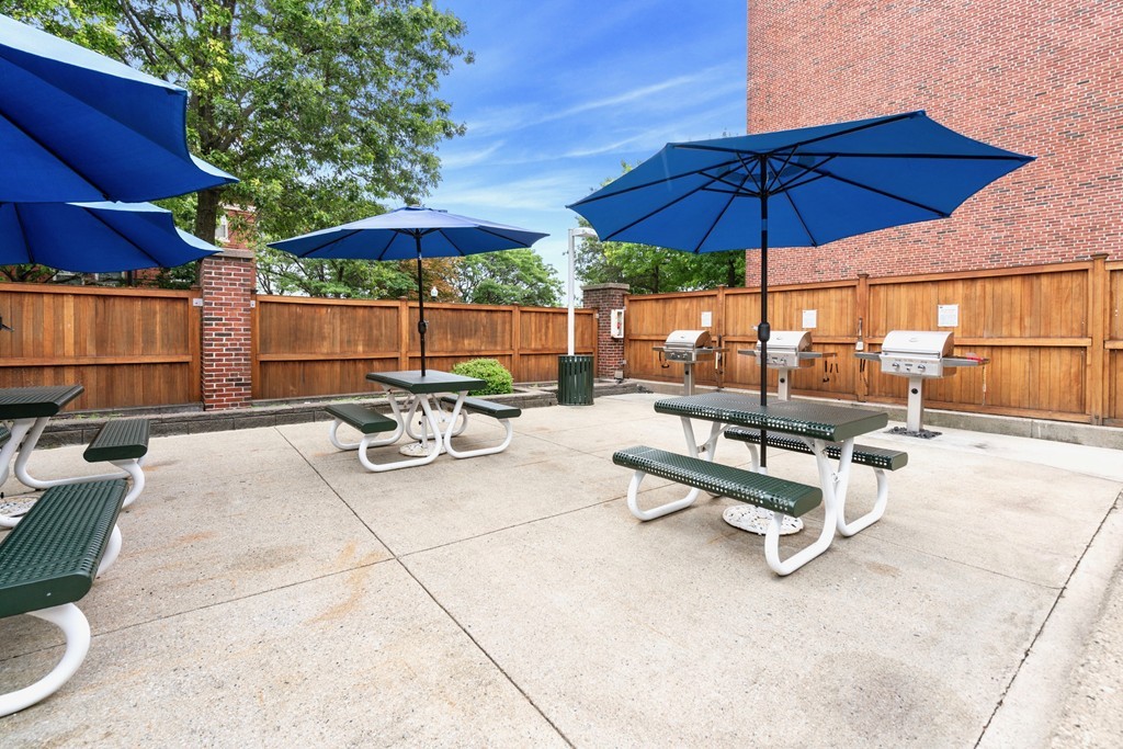 42 8th Street, Unit 5109 Boston, MA 02129 - Photo 13 of 17 a view of a backyard with chairs under an umbrella