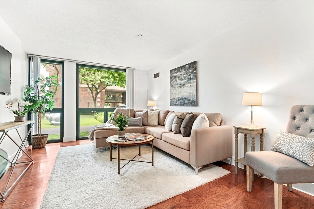 42 8th Street, Unit 5109 Boston, MA 02129 - Photo 2 of 17 a living room with furniture and a large window