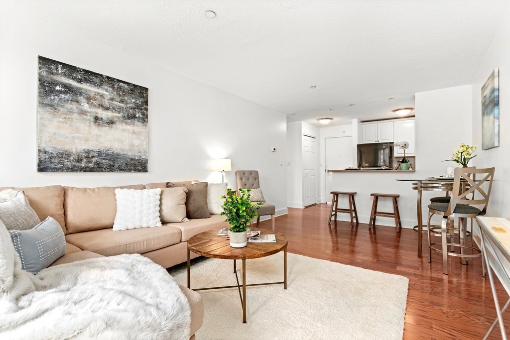 42 8th Street, Unit 5109 Boston, MA 02129 - Photo 5 of 17 a living room with furniture wooden floor and kitchen view