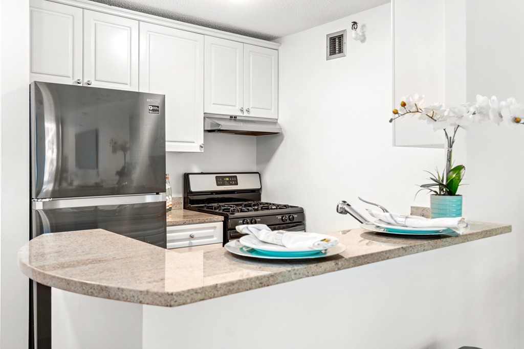 42 8th Street, Unit 5109 Boston, MA 02129 - Photo 7 of 17 a kitchen with sink refrigerator and stove