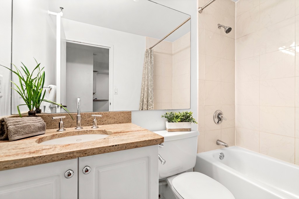 42 8th Street, Unit 5109 Boston, MA 02129 - Photo 10 of 17 a bathroom with a granite countertop sink mirror vanity and toilet