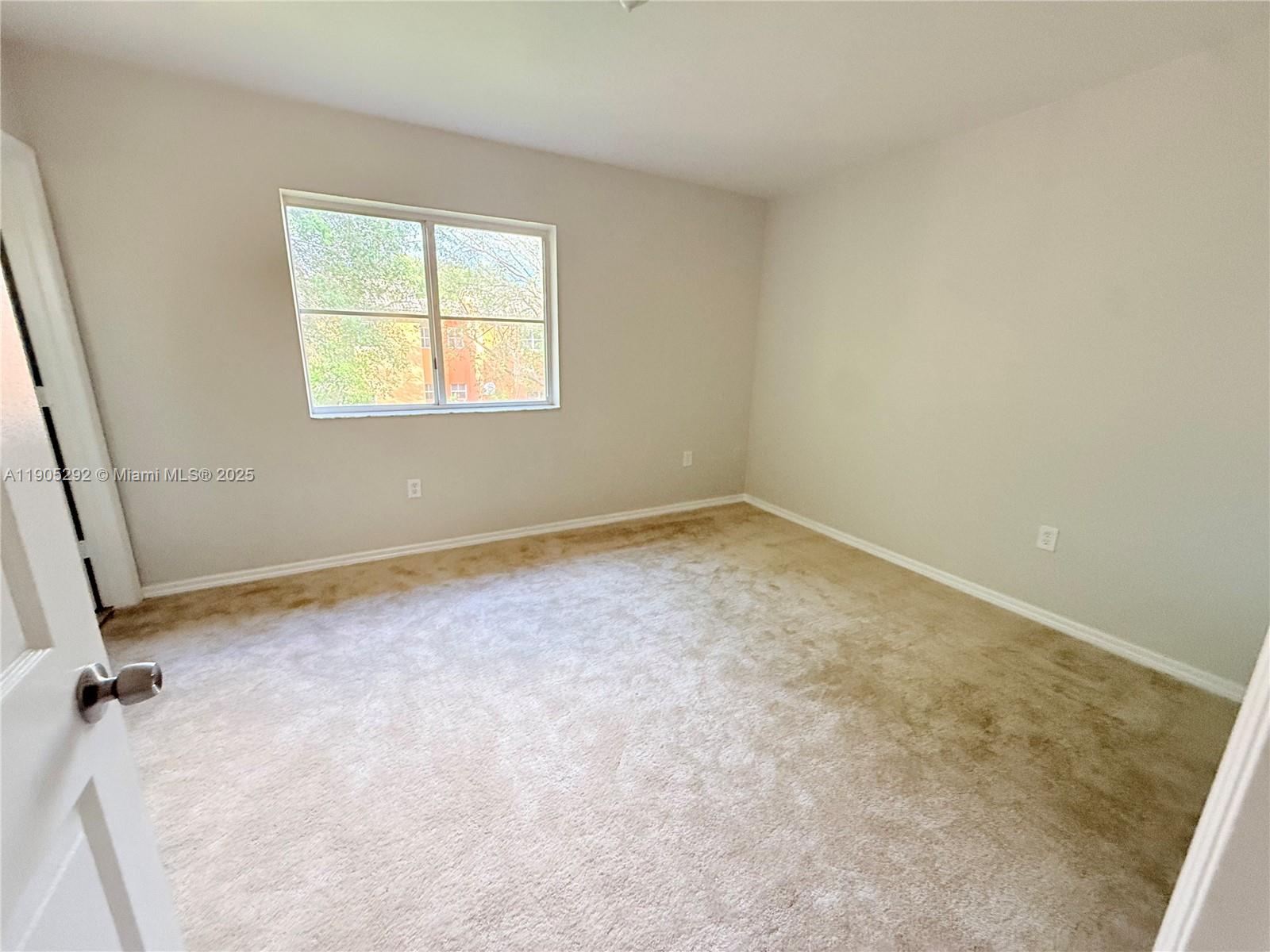 656 Southwest 11th Street, Unit 656 Florida City, FL 33034 - Photo 16 of 18 an empty room with a window