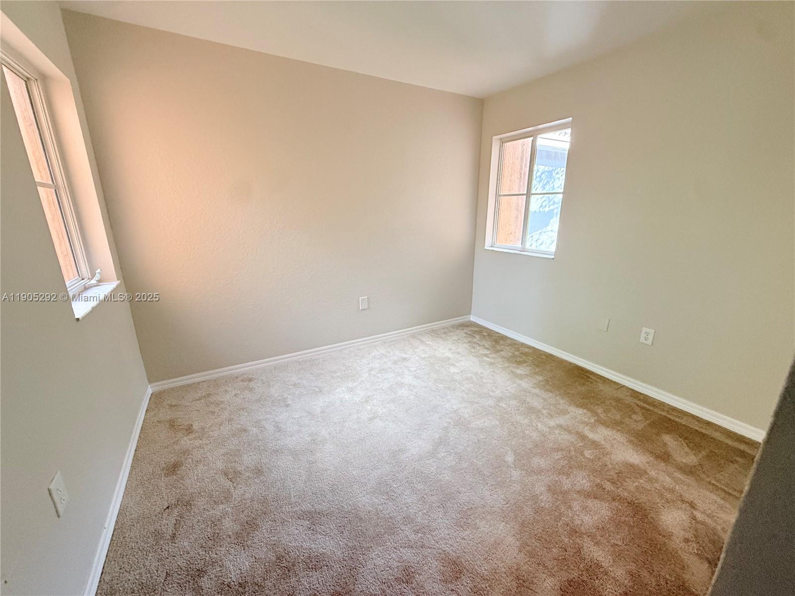 656 Southwest 11th Street, Unit 656 Florida City, FL 33034 - Photo 17 of 18 an empty room with windows