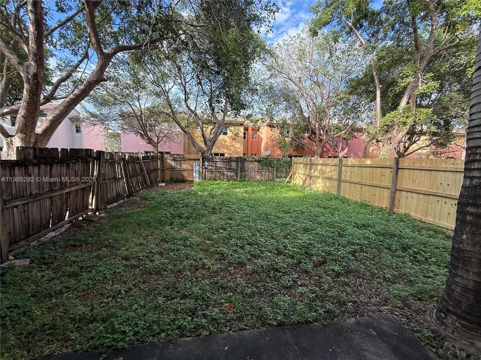 656 Southwest 11th Street, Unit 656 Florida City, FL 33034 - Photo 4 of 18 a view of a backyard with wooden fence