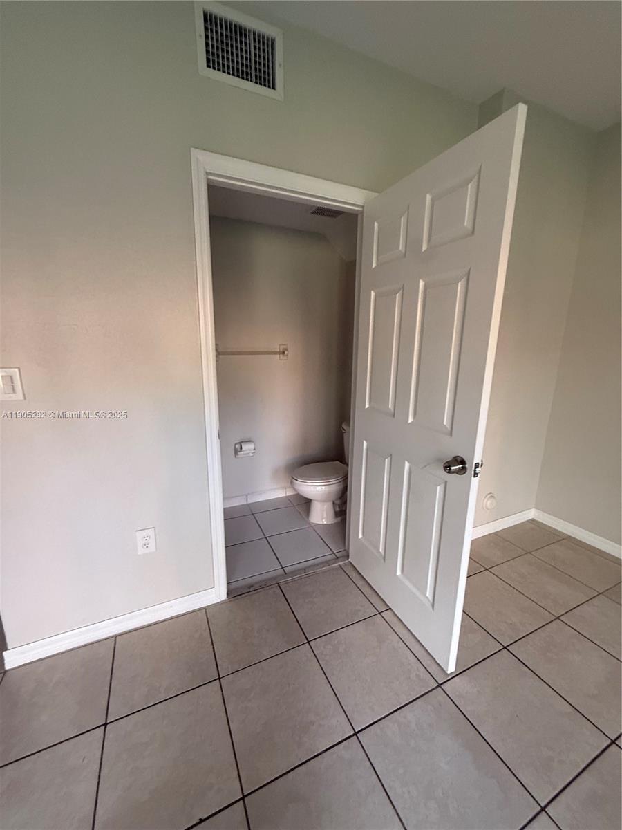 656 Southwest 11th Street, Unit 656 Florida City, FL 33034 - Photo 5 of 18 a bathroom with a sink and a toilet