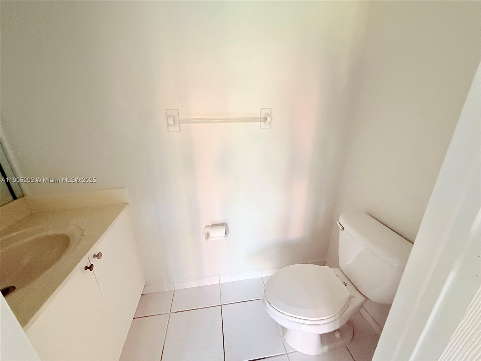 656 Southwest 11th Street, Unit 656 Florida City, FL 33034 - Photo 6 of 18 a white toilet sitting next to a bath tub