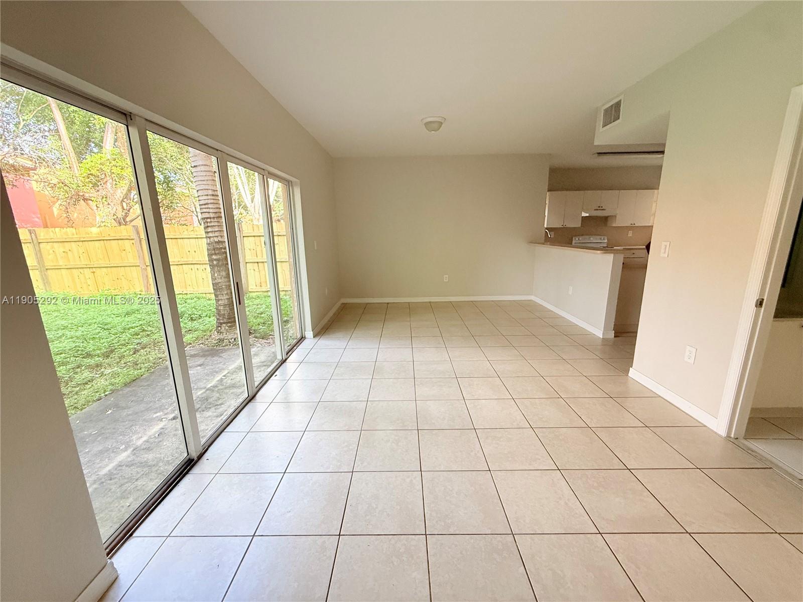 656 Southwest 11th Street, Unit 656 Florida City, FL 33034 - Photo 9 of 18 a view of empty room with wooden floor and fan