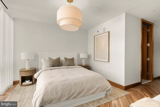 a bedroom with a bed and a mirror