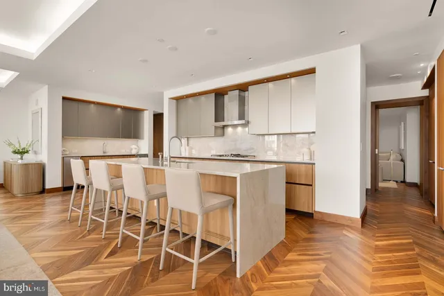 a kitchen with cabinets and chairs