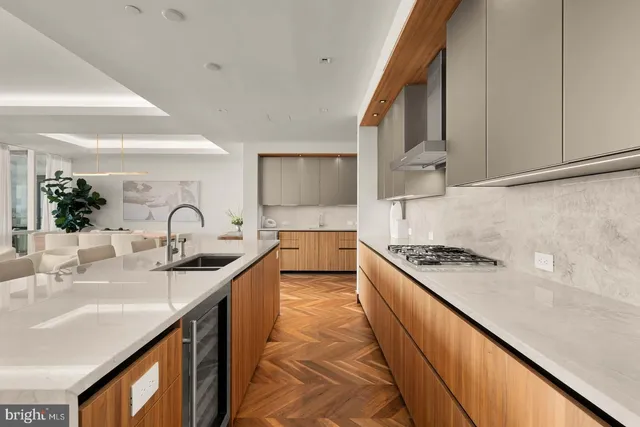 a kitchen with stainless steel appliances granite countertop a sink stove and cabinets
