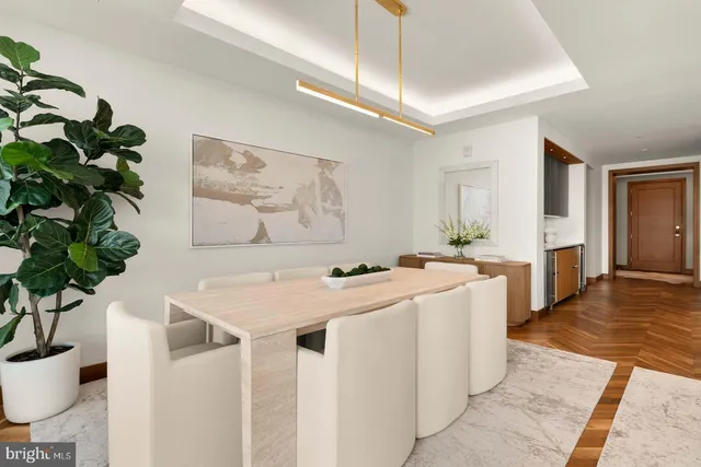 a view of a kitchen area with furniture and wooden floor