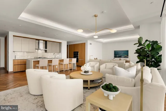 a living room with furniture a chandelier and a dining room