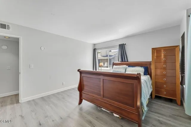 a bed room with a bed and a chair