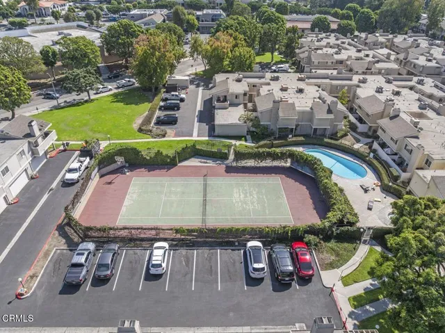 an aerial view of a house with a swimming pool patio and outdoor seating
