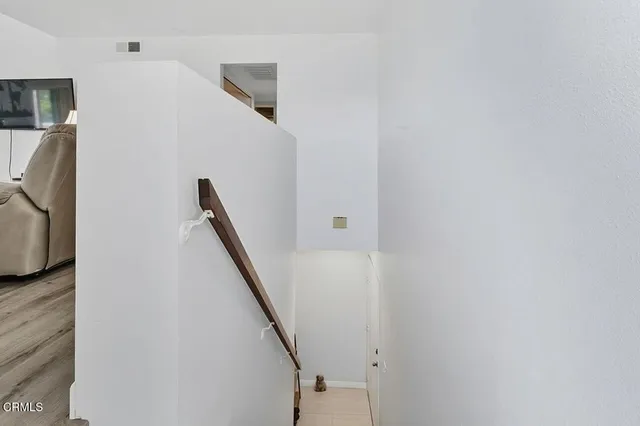 a view of storage and utility room with wooden floor