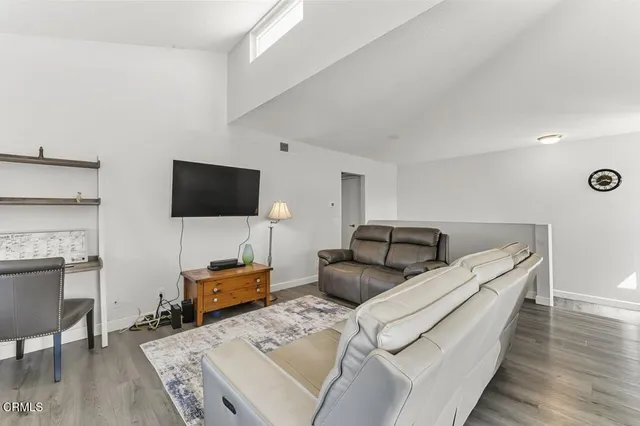 a view of a dining room with furniture large windows and wooden floor