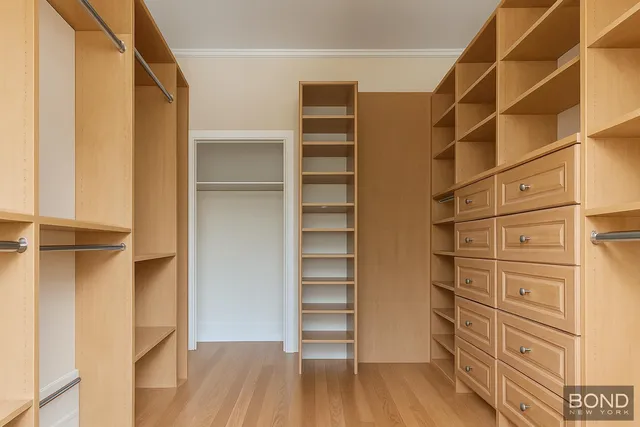 a view of walk in closet with empty racks