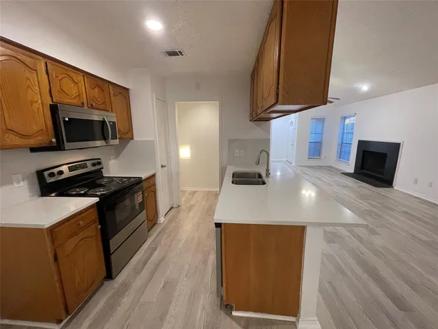 a kitchen with stainless steel appliances a stove microwave and a refrigerator