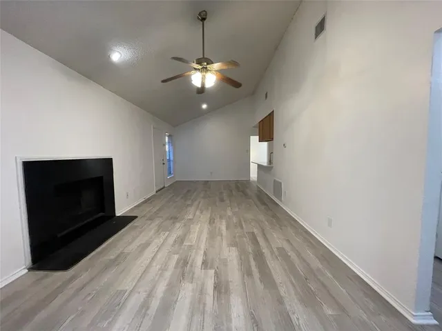 wooden floor in an empty room with a fireplace