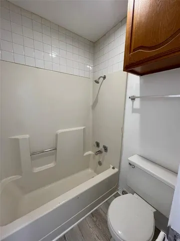 a bathroom with a toilet and a bathtub