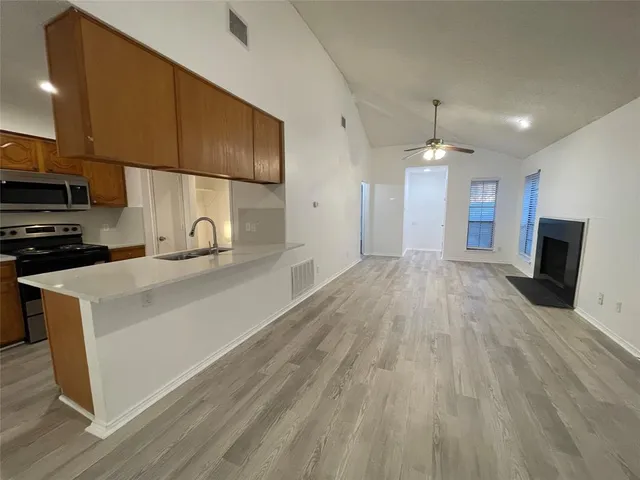 a view of a kitchen with a sink and microwave