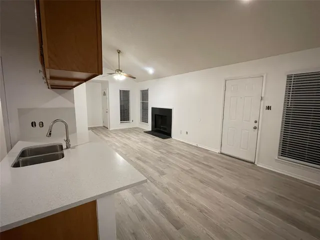 a view of a kitchen with a sink and dishwasher wooden floor