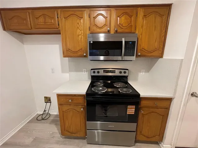 a stove top oven sitting inside of a kitchen