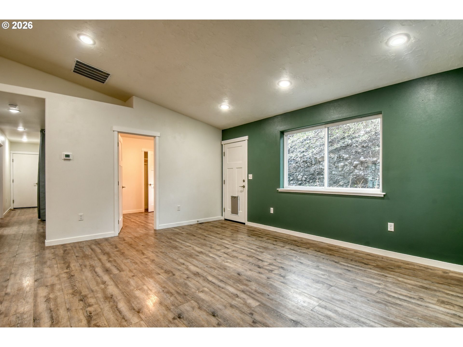 2010 Tutuilla Road Pendleton, OR 97801 - Photo 11 of 38 a view of an empty room with wooden floor and windows