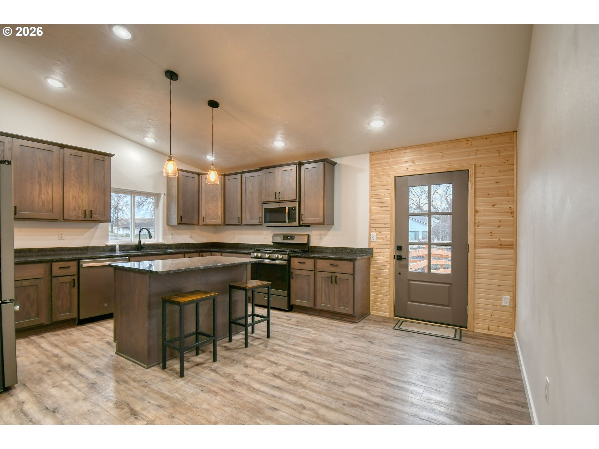 2010 Tutuilla Road Pendleton, OR 97801 - Photo 6 of 38 a kitchen with stainless steel appliances granite countertop a sink counter space and wooden floor