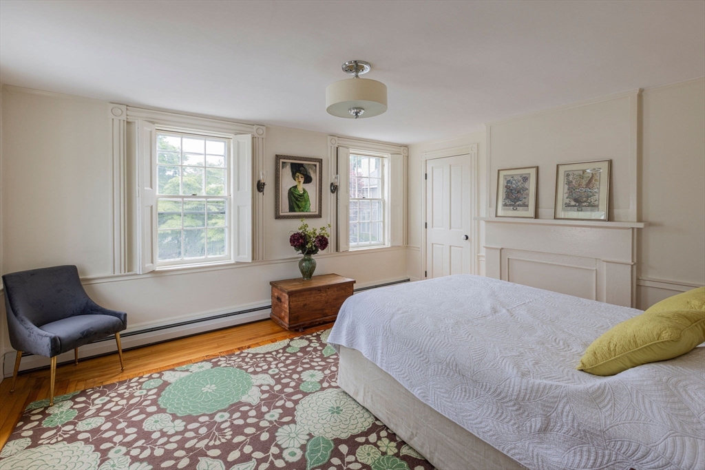7 Waldron Court Marblehead, MA 01945 - Photo 11 of 26 a bedroom with a bed chair and two windows